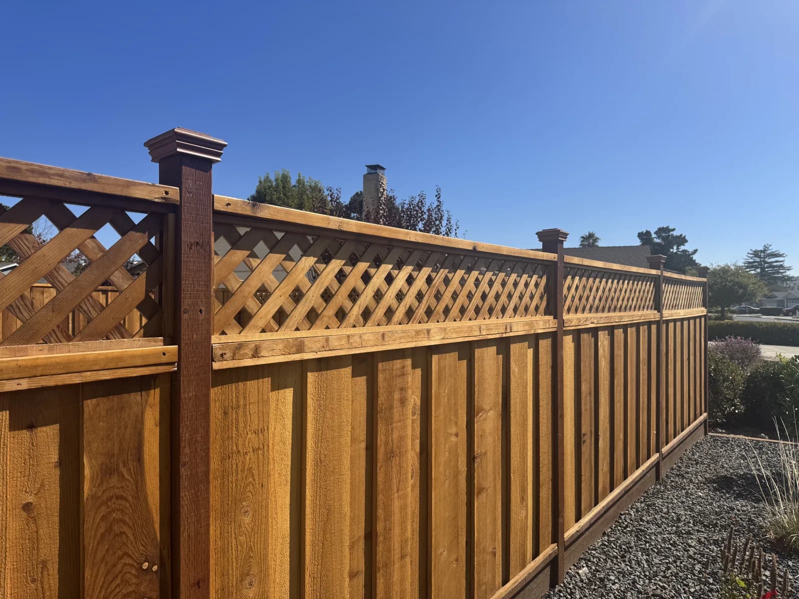 Redwood privacy fence with lattice top and post caps